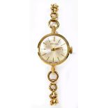 GARRARD; a lady's 9ct yellow gold bracelet watch, the circular dial set with baton numerals,