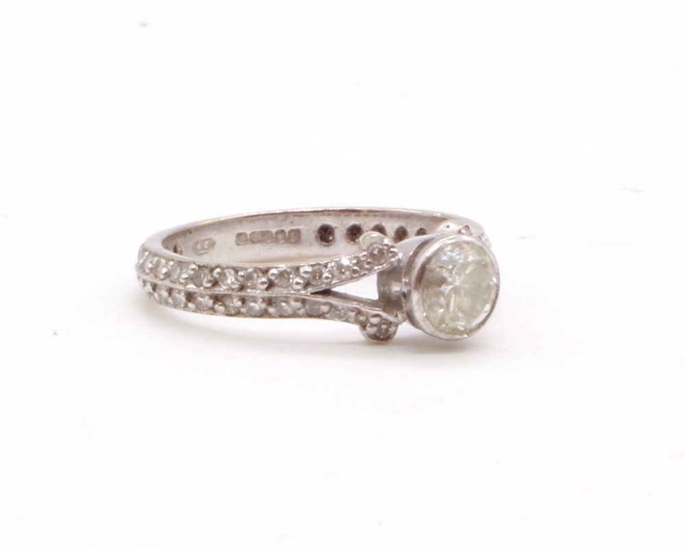 A modern 18ct white gold diamond solitaire ring, the principal collet set stone weighing approx 0.