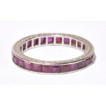 A white metal ruby full eternity ring set with square cut rubies throughout, size N1/2, approx 3.