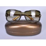 GUCCI; a pair of ladies gold and beige rimmed sunglasses with case.