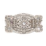 A French Art Deco white metal and diamond plaque brooch of pierced shaped rectangular form, the