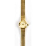 TISSOT; a lady’s vintage 9ct yellow gold wristwatch, the circular dial set with gold baton