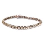 A 14ct white gold diamond set tennis bracelet with thirty four round brilliant cut stones, length