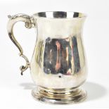 CHARLES WRIGHT; a George III hallmarked silver mug of baluster form with C-scroll handle, raised