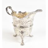 An 18th century and later decorated Irish hallmarked silver cream jug with loop handle and