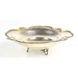 A 0.830 grade silver footed bowl with cast floral rim, diameter 21cm, approx 6.76ozt/210.6g.