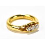 A 22ct yellow gold three stone diamond ring, the largest diamond weighing approx .10ct, size N,