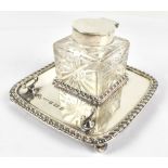 RR; a Victorian hallmarked silver ink stand with silver mounted clear cut glass inkwell and pen
