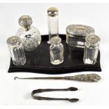 Six Victorian and later silver topped dressing table bottles including a bulbous example, London