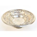 An Israeli white metal footed bowl with repoussé floral decoration surrounding chased panels