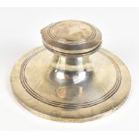 CARRINGTON & CO; an Edward VII hallmarked silver capstan-type inkwell with domed hinged lid above