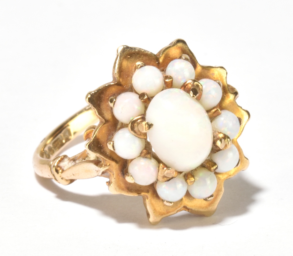 A 9ct yellow gold and opal floral set ring, size M, approx 4.6g.Additional InformationThe ring has