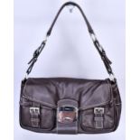 PRADA; a soft brown leather shoulder bag with two front buckle pockets and silver hardware, 28 x