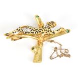 An 18ct yellow gold brooch modelled as a cheetah in a tree set with several small diamonds and