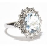 An 18ct white gold aquamarine and diamond dress ring, the oval aquamarine weighing approximately