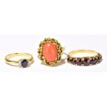 An 18ct yellow gold diamond and sapphire ring, size I, a yellow metal coral set ring, and a