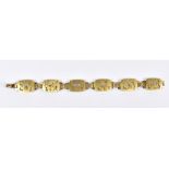 A 9ct yellow gold bracelet formed of six pierced rectangular panels, each decorated with a different