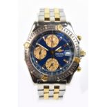 BREITLING; a gentleman's stainless steel bimetallic wristwatch, the blue dial set with three