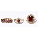 Three 9ct yellow gold garnet dress rings, largest size M, approx 9g.Additional InformationMarks