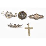 A collection of four brooches, three hallmarked silver examples and one with applied hard stones and