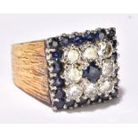 A gentleman’s yellow metal stepped and panelled ring set with diamonds and sapphires, the eight