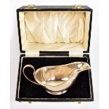 CHARLES BRADBURY & SONS; an Elizabeth II hallmarked silver cased sauce boat of simple form,