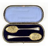 WALKER & HALL; two Victorian hallmarked silver berry spoons with gilt bowls and chased decoration to