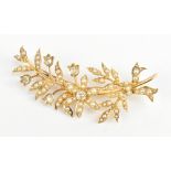 A yellow metal diamond and cut cultured pearl floral brooch set with five small diamonds within a