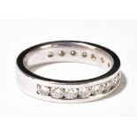 A platinum and diamond three quarter enternity ring set with sixteen round brilliant cut stones,