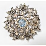 A 19th century white metal diamond and aquamarine brooch/pendant with openwork frame centred with an