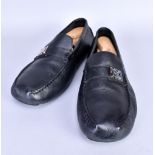 LOUIS VUITTON; a pair of soft black leather slip-on loafers with silver tone buckle detail (size 9.