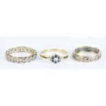 Three 9ct gold dress rings including a floral decorated example and two full eternity rings, sizes