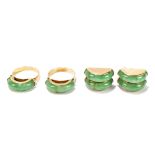 A pair of yellow metal and jade domed rings, size K, and a pair of matching double domed earrings,