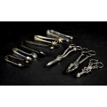 A group of various hallmarked silver and plated items to include sugar tongs,