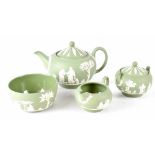 A Wedgwood sage green four-piece tea set to include teapot, lidded sucrier, milk jug and slop bowl,