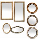 Seven gilt-framed contemporary mirrors to include two rectangular examples, two oval examples,