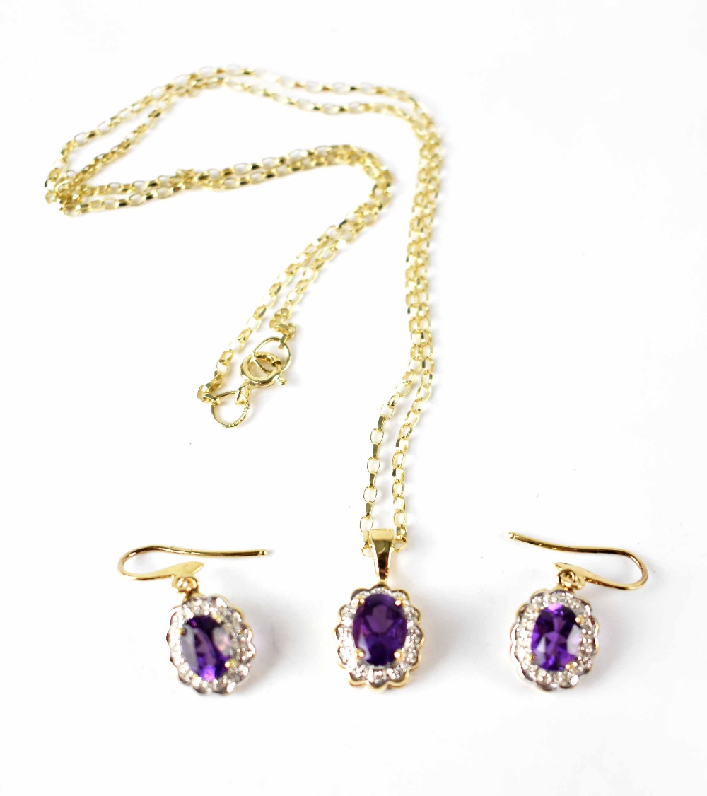 A diamond and amethyst cluster necklace and earring set,