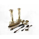 A pair of hallmarked silver Corinthian column candlesticks with swag and bow repoussé decoration,