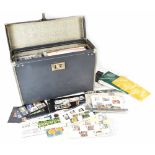 A vintage carrying case containing a large number of first day covers to include commemorative