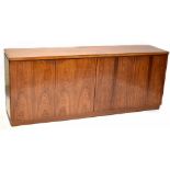 A mid-20th century rosewood sideboard comprising two pairs of cupboard doors,