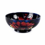 A Moorcroft small bowl, cobalt blue ground in anemone pattern, green marks to base, diameter 16cm.