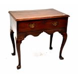 A Georgian mahogany lowboy with single drawer with brass drop handles above a shaped frieze,