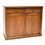 An Edwardian mahogany dresser base comprising two drawers and a pair of fielded and panelled