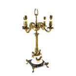 A table lamp in the form of an Empire-style gilt metal four-branch candelabrum,