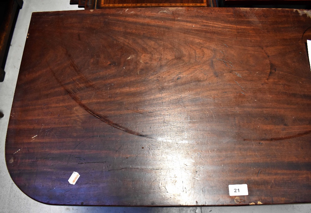 A William IV mahogany fold-over tea table supported on carved and turned tapering legs with brass - Image 3 of 4