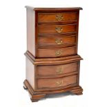 A reproduction mahogany bow-fronted chest-on-chest of six drawers, on ogee cabriole legs,