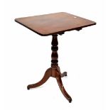 A Georgian mahogany rectangular tilt-top occasional table on turned column and tripod outswept base