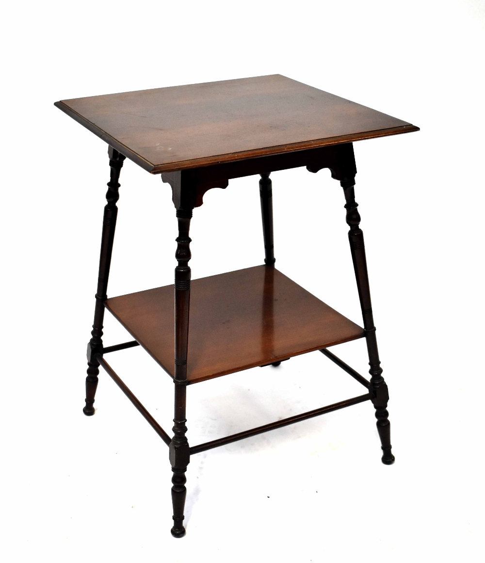 An Edwardian mahogany square-topped occasional table on ring turned legs with undershelf and