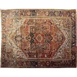 An Iranian wool Shiraz rug with central medallion within stylised floral motifs and floral