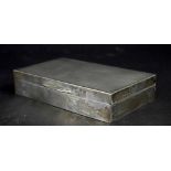 A George VI hallmarked silver engine turned cigarette box with interior wood lining, length 15cm,